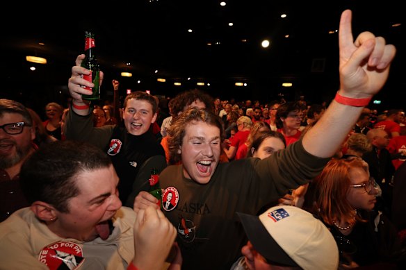 Elated ALP supporters at the Canterbury-Hurlstone Park RSL Club celebrate Anthony Albanese's victory. 