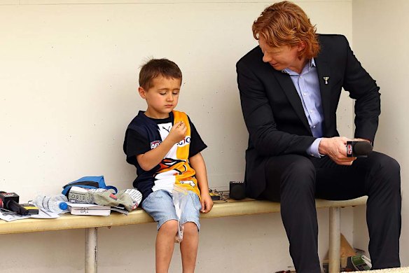 Commentator Cameron Ling talks to a young Eagles fan.