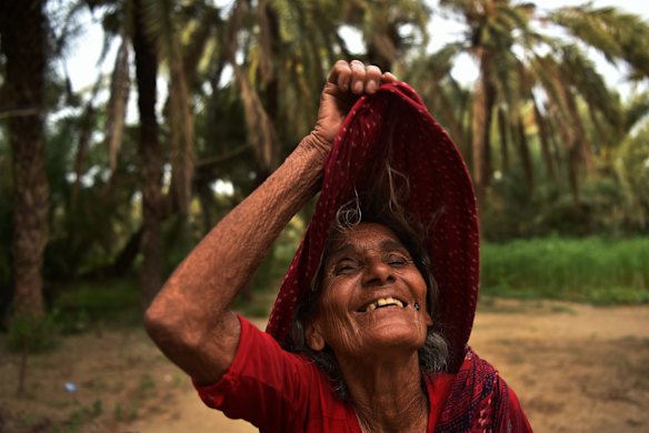 Traditional date palm farmer Megbai Gadhavi on the family's farm in Navinal village, near Mundra. According to Gadhavi, Adani's nearby port and power plant have increased the salinity in the water supply; fly ash from the power plant is also killing causing the palms. Gadhavi's crop yield has dropped 50 per cent since Adani began operating.