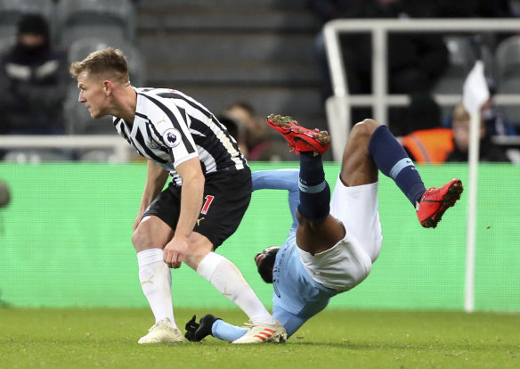 Newcastle United's Matt Ritchie (left) sends City's Raheem Sterling to the deck.