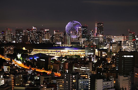 A drone display is seen over the top of the stadium during the Opening Ceremony.