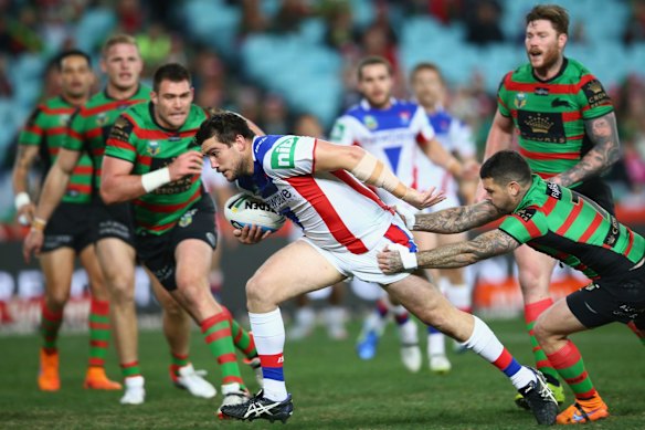 Making a break for it: Kade Snowden of the Knights tries dodge the Rabbitohs defence. 