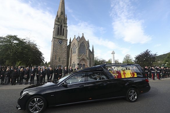 Members of the public line the streets in Ballater, Scotland, as the hearse carrying the coffin of Queen Elizabeth II passes through as it makes its journey to Edinburgh from Balmoral in Scotland.