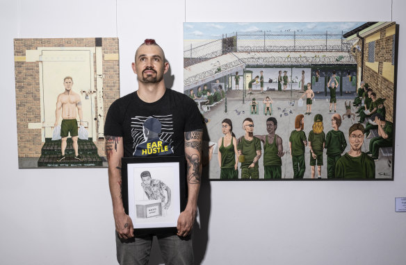 Damien Linnane, former prisoner turned artist holding his artwork at an exhibition at Boom Gate Gallery. 