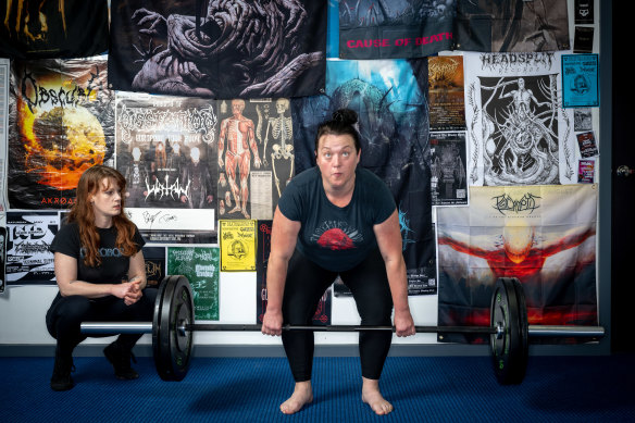 Client Shay Murphy performs deadlifts while Jewel monitors her technique. 