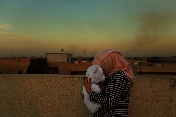 A female internally displaced person (IDP) hugs a teddy bear given to her by her now husband, the one precious possession she has from home when fleeing from ISIS in Fallujah