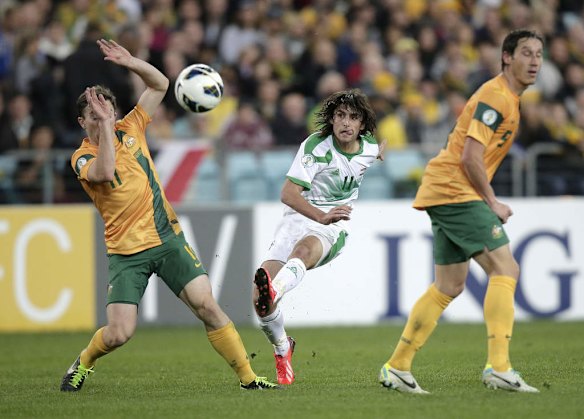 Iraq's Human Tareq Faraj, center, attempts a long range goal between the Australian defenders Tommy Oar, left, and Rhys Williams.
