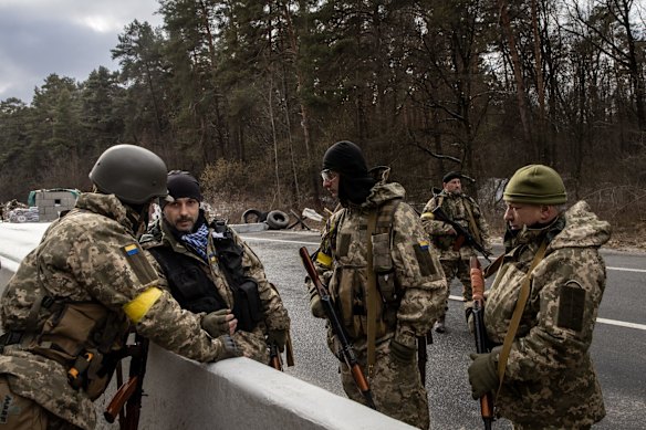 Members of the Ukrainian military arrive to reinforce a forward position on the eastern front-line near Kalynivka village in Kyiv, Ukraine.