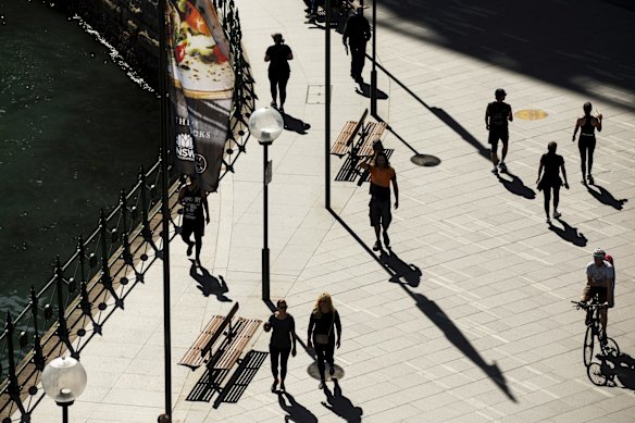 People observe social distancing as they exercise at Circular Quay.