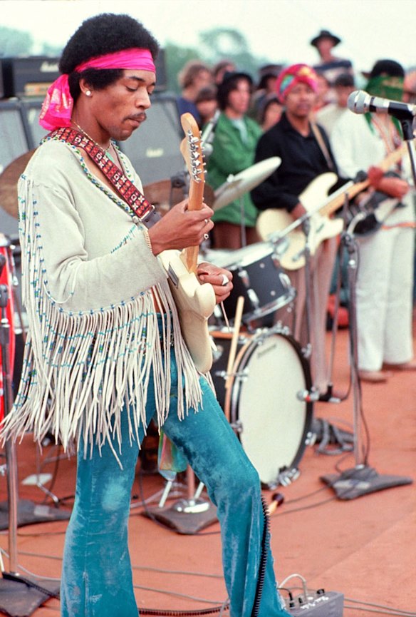 Musician Jimi Hendrix performs at Woodstock.
