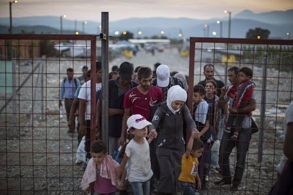 After crossing the Greek Macedonian border and having papers processed, migrant families walk out of the transit area towards Gevgelija train station to find transport North to the Serbian border.