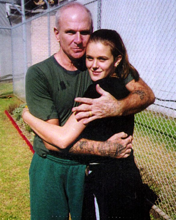 Life term ... Smith receives a hug from daughter Jaime during a jail visit. Today he is wheelchair bound and ravaged by the effects of adavnced Parkinson's disease.