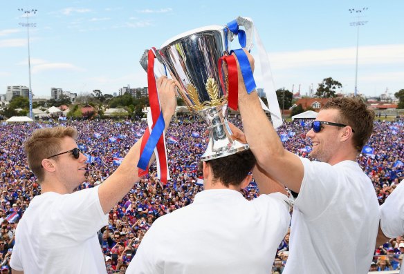 Tumble town: The Western Bulldogs were all smiles when they celebrated their 2016 premiership, but by the end of ’17 they had missed the finals, and Jake Stringer (right) had left the club.