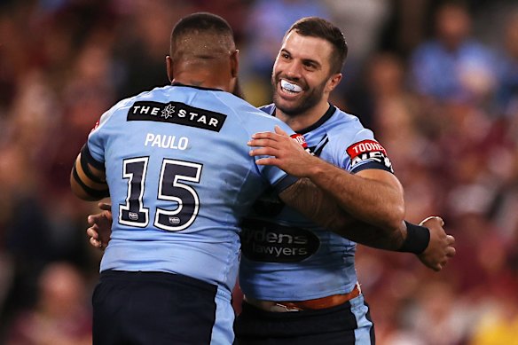 James Tedesco of the Blues and Junior Paulo of the Blues celebrate after winning game one of the 2021 State of Origin series.