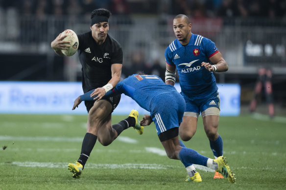 Flyer: Rieko Ioane, left, is tackled by France's Benjamin Fall.