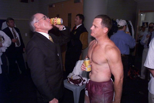 John Howard drinks a beer with Bronco Kevin Walters after Brisbane won the 1998 NRL grand final.