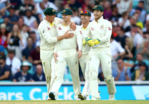 Steve Smith celebrates with his teammates after catching out Chris Woakes.