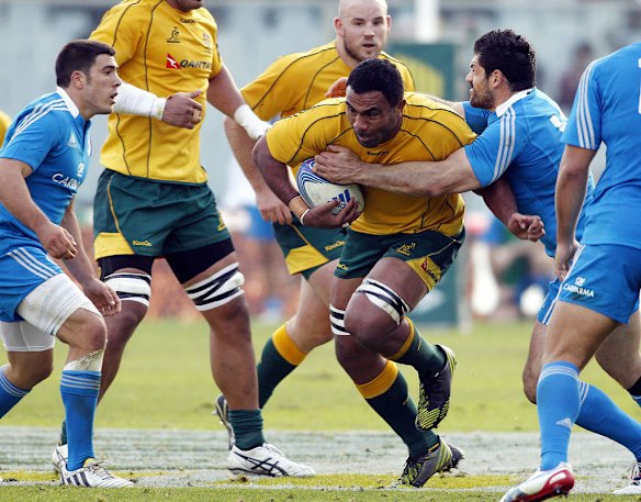 Italy's Andrea Masi tries to stop Australia's Wycliff Palu.