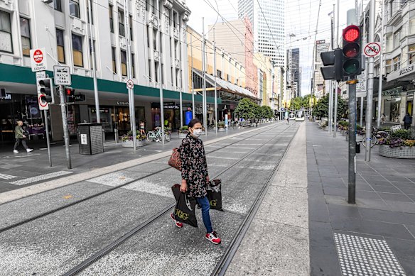 Bourke Street mall, Melbourne. March 18, 2020.

“The photo of a lone woman in Bourke Street mall with the surgical mask was one of many images  I shot when the city first went into lockdown. Peak hour on Melbourne’s busiest street with just one person with a face mask, a few distant figures in the frame – it’s a scene that we’ve never witnessed until the crisis hit. The woman looks scared and somewhat annoyed that I took the photo. I think that speaks a little to the weariness people are feeling from this seemingly omnipresent viral threat." – Justin McManus, photographer at The Age, who has lived in Melbourne for the past 14 years.
