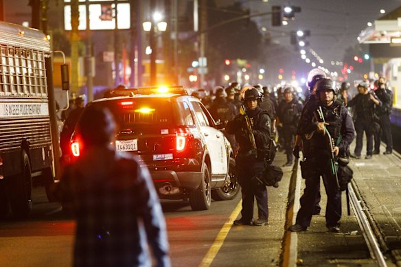 Los Angeles Police Department (LAPD) officers clear demonstrators from train tracks after declaring an unlawful assembly on election night in Los Angeles, California, U.S.