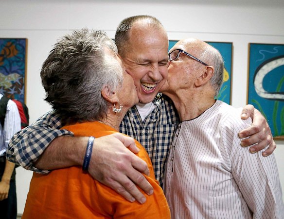 Greste gets a kiss from his mother Lois and father Juris.