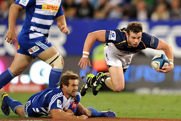 Robbie Coleman of the Brumbies skips over the tackle by Nick Groom of the Stormers.