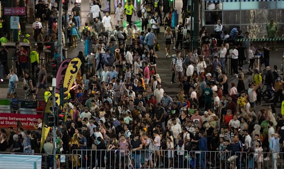 People arrive at Flinders Street Station for New Years Eve celebrations.