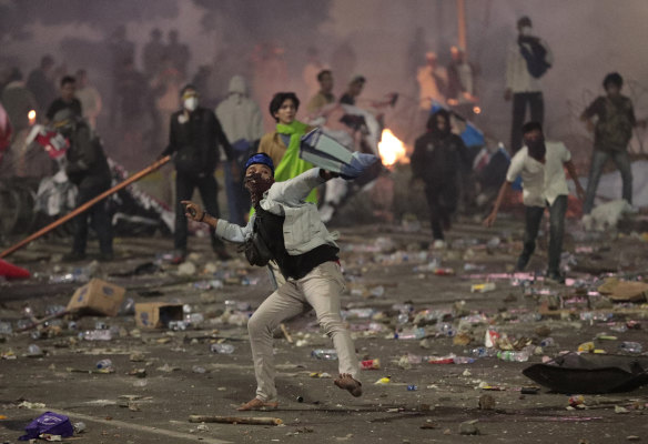 Supporters of losing Indonesian presidential candidate Prabowo Subianto throw rocks at police during clashes in Jakarta on May 22.