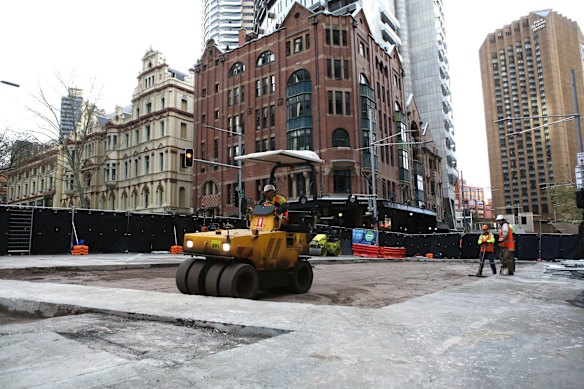 Workers prepare the road surface as progress continues on the Sydney Light Rail on the corner of Bridge and George St.