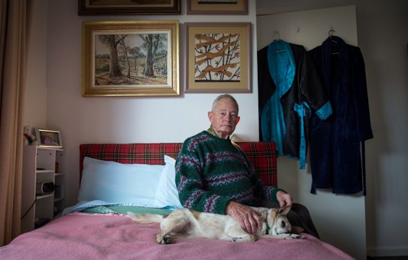 Geoff Richards in bedroom with Harry's favourite artwork above his bed and their very old dog Tosh. When his partner of 55 years Harry died the retirement home he was living in, kicked him out because they wouldn't recognise their relationship.