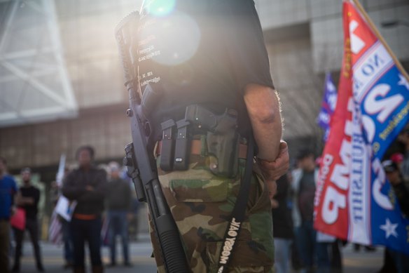 A demonstrator carries a firearm at a pro-Trump protest in front of the TCF Center during the 2020 Presidential election in Detroit, Michigan.