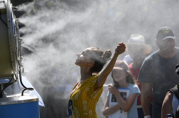 Spectators try to keep cool at a sizzling day at the Australian Open in early 2019.