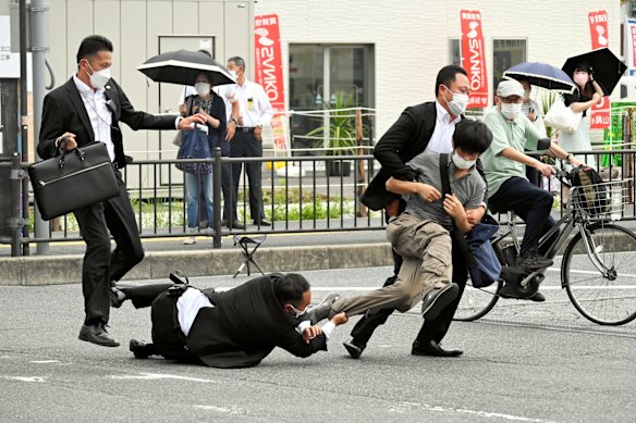Security police tackle a suspect shortly afterwards.