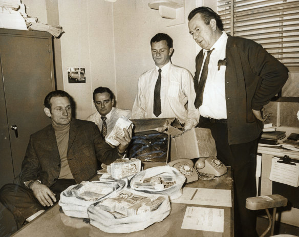 CIB officers recover more money from the Qantas bomb hoax from a shop in Annandale on 6 August 1971.