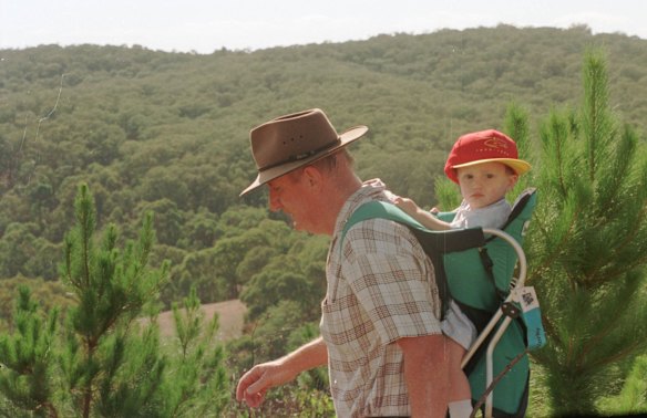 Tim Fisher with his son Dominic, 18 months, near the old Wagga to Tumbarumba rail line.