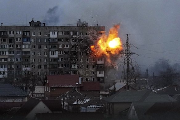 An explosion is seen in an apartment building after Russian's army tank fires in Mariupol, Ukraine.  