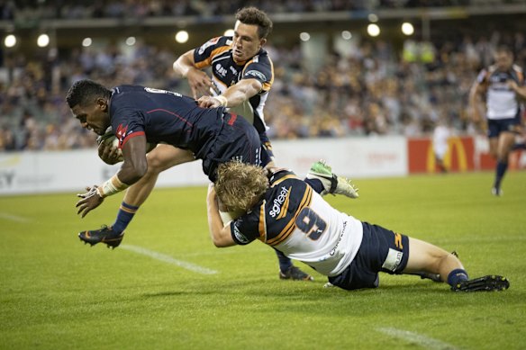 The Brumbies' Tom Banks and Joe Powell tackle the Rebels' Isi Naisarani. 