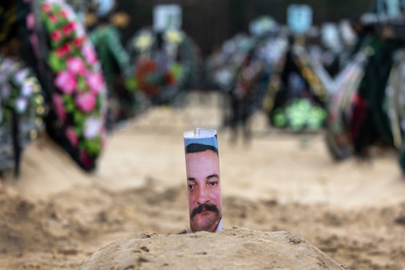 A simple portrait adorns a grave in the Irpin cemetery. At least 700 murdered civilians have been found in towns around Kyiv, according to authorities. The slayings launched investigations for possible war crimes perpetuated by Russian forces during the occupation.