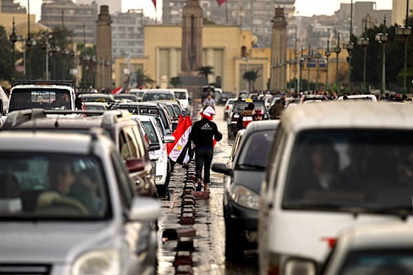 An Egyptian street vendor sells flags amid a traffic jam leading to Cairo's Tahrir Square.