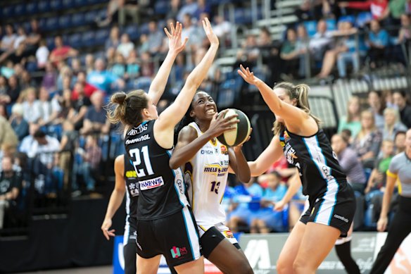 Boomers' Ezi Magbegor tries to get through Capitals' Keely Froling and Lauren Scherf. 