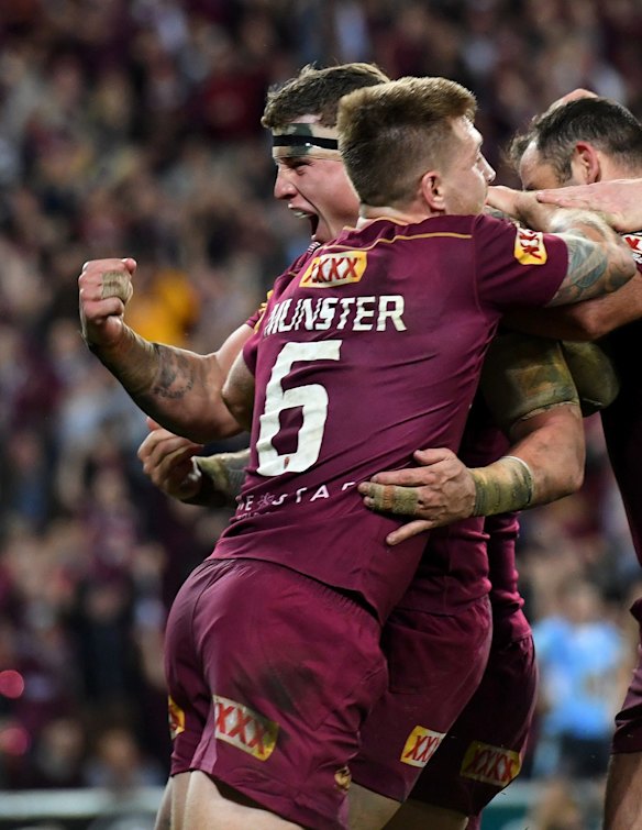 Jarred Wallace of the Queensland Maroons (left) celebrates. 
