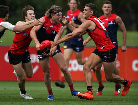 Hunt and gather: Bombers surround Melbourne's Jayden Hunt.