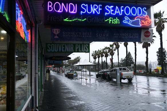 Bondi Beach is quiet, as inclement weather and tough new COVID-19 lockdown restrictions limit people's movement across Greater Sydney.