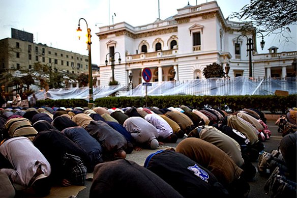 Egyptian anti-government protesters pray outside the parliament, located some 500 metres from Cairo's Tahrir Square.