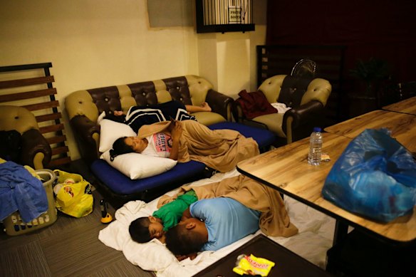 Guests sleep inside a hotel restaurant after the roof of their room was partly damaged due to strong winds from Typhoon Mangkut in Tuguegarao city, Cagayan province, northeastern Philippines. 