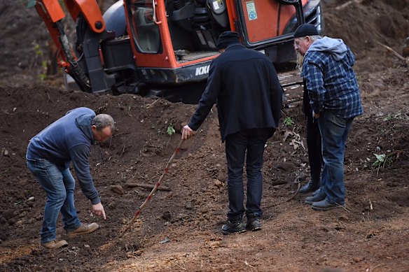 A backhoe running over the soil in the Royal National Park came to a sudden halt about 2.30pm after the driver spotted bones. Pictured a NSW Detective shows Matthew Leveson's parents Mark Leveson (right) and Faye Leveson (2nd from right) where there may be the burial place of their son Matthew Leveson.