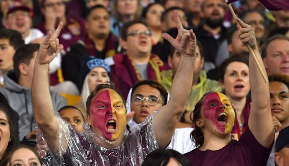 Queensland fans celebrate the first try to Valentine Holmes.