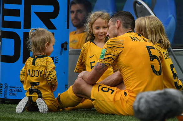 Family man: Mark Milligan with his kids after the loss to Peru.