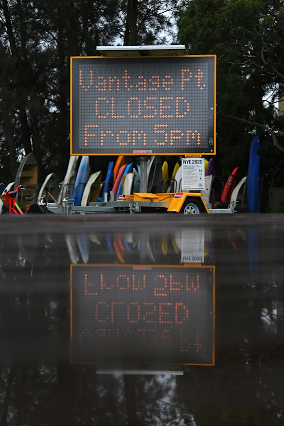 A sign displaying COVID-19 messaging in Tingira Memorial Park, which has been closed as a precaution against coronavirus, at Rose Bay.