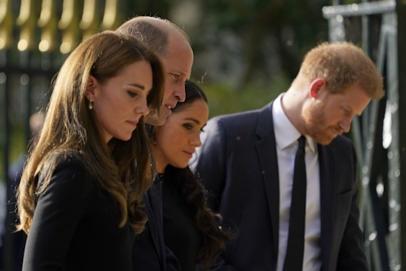 Britain's Prince William and Catherine, Princess of Wales, left, and Britain's Prince Harry and Meghan, Duchess of Sussex walk to greet the crowds after viewing the floral tributes for the late Queen Elizabeth II outside Windsor Castle.